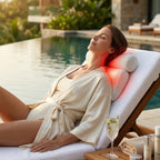 Woman relaxing on a lounge chair by a pool with a neck pillow, enjoying a glass of wine.
